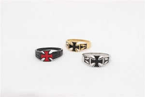 Macro view of vintage stainless steel rings featuring iron cross and lightning patterns