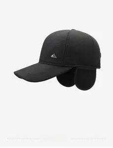 Detail view of thick black winter baseball cap with earflaps and metal triangle decor