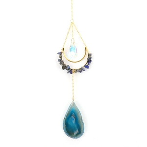 Detail of moon-shaped suncatcher with blue agate slice and natural crystal stones