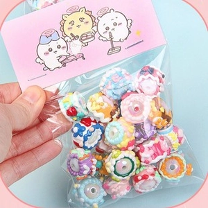 Close-up of colorful hand-painted acrylic beads in packaging for DIY jewelry making