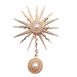 Golden sunburst star pendant with faux pearl accents and elegant metallic finish
