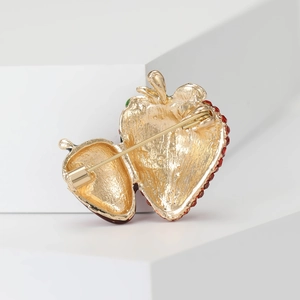 Back view of minimalist golden strawberry brooch with secure pin clasp and red enamel finish