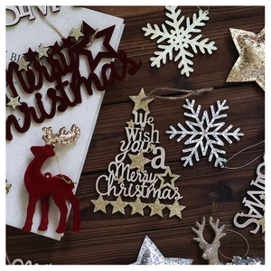 Close-up of red flocked reindeer and wooden Christmas tree tags on a rustic wood background
