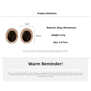 Detail view of oval vintage earrings with black gemstone and crystal pavé on gold frame
