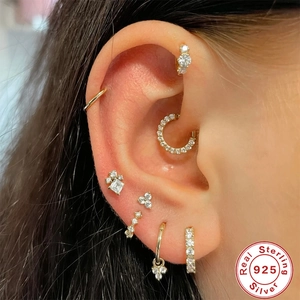Set of gold S925 sterling silver cartilage earrings with CZ stones on a female ear