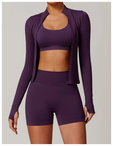 Detail of deep purple yoga set showing zipper stand collar and thumbhole cuffs design