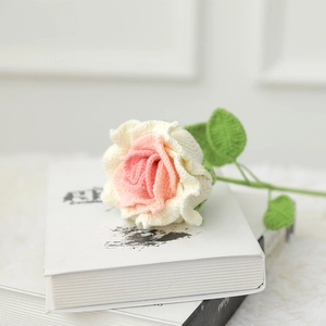 Handmade crochet pink and cream rose flower on books for elegant home decor