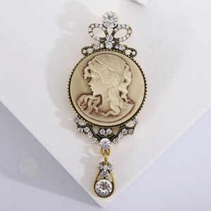 Vintage relief brooch with woman portrait cameo and sparkling rhinestones on stand