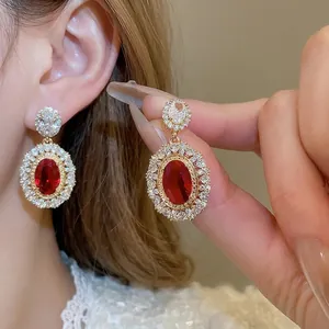 Elegant gold-plated oval red zircon drop earrings with shimmering crystal accents