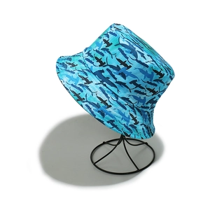 Detail of light blue sun hat featuring navy marine life silhouettes and reinforced brim