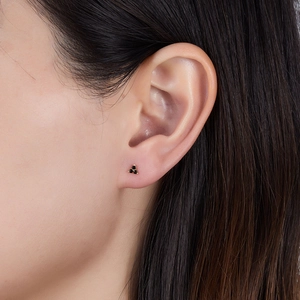 Detail view of s925 silver stud earrings with black stones in a three-petal flower design