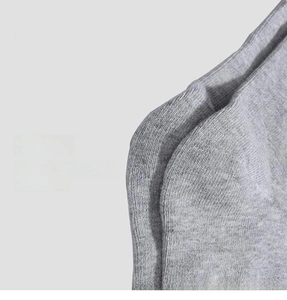 Detailed close-up showing the reinforced heel stitching on gray cotton knit socks