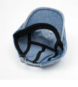 Detailed interior of a blue denim beret showing twill lining and neat stitching quality