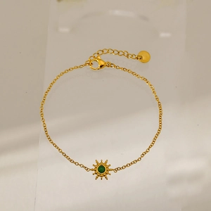 Detail of gold sunburst pendant bracelet with green stone and adjustable lobster clasp