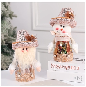 Close-up of festive Christmas candy jars featuring Santa and snowman with sequined hats