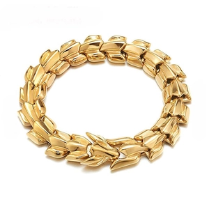 Detail of gold dragon scale link bracelet with retro punk metal texture and shine