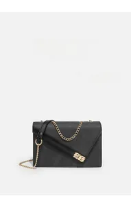 Detail of cross-grain leather texture and golden chain strap on a black envelope bag