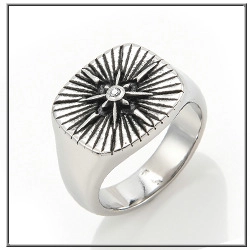 Macro detail of men's titanium steel signet ring with radial texture and crystal inlay