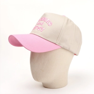 Close-up of pink letter embroidery on a beige and pink color-block cotton baseball cap