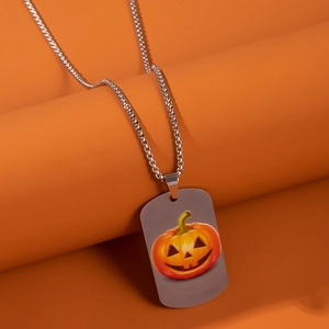 Close-up of a stainless steel military dog tag necklace with a colorful Halloween pumpkin