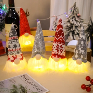Macro detail of diverse LED Christmas gnomes with knit patterns and warm glowing lights