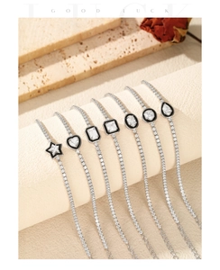 Detailed view of silver S925 bracelets featuring black enamel and geometric pendants
