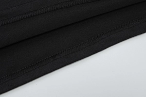 Close-up of high-quality double-stitched hem on a black sleeveless backless dress