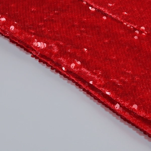 Macro shot of sequins texture and satin fabric on wine red V-neck mermaid evening dress