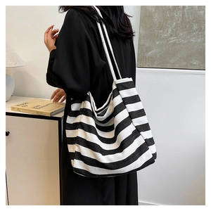 Detail shot of the large black and white striped canvas tote bag with long shoulder straps
