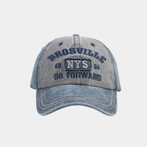 Close-up of vintage washed denim baseball cap with embroidered Brosville and NYS patches