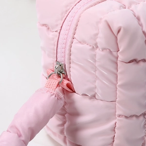 Portable pink quilted cosmetic bag with high-capacity design and durable zipper detail