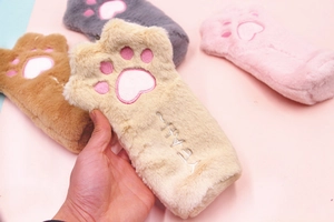 Close-up of soft plush cat paw pencil cases with pink embroidered pads in four colors
