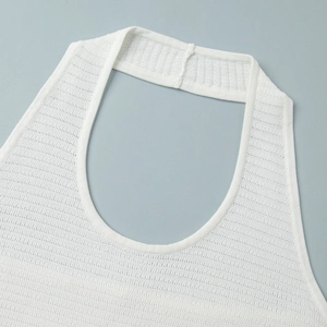 Close-up of white knit halter neck top showing fine ribbed texture and quality stitching