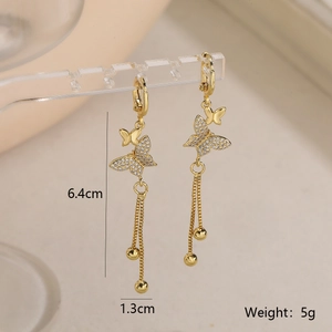 Detail of butterfly tassel earrings in 18k gold plating with white zircon stones