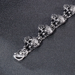Macro shot of a gothic skull bracelet with ornate fleur-de-lis lobster clasp detail