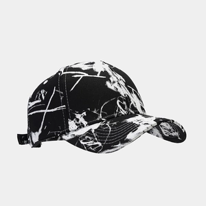 Detail view of cotton canvas baseball cap featuring white graffiti splatter and stitching