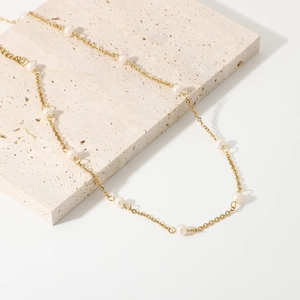 18K gold plated stainless steel necklace with natural freshwater pearls on a stone plate