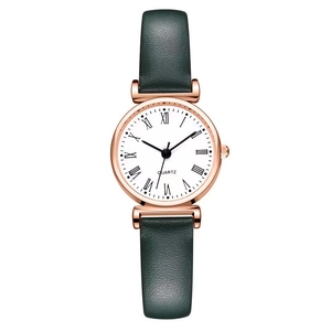 Elegant women's quartz watch with rose gold case and green leather strap on white background