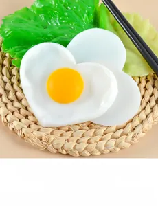 Macro detail of heart-shaped fried egg model with lettuce on woven tray background