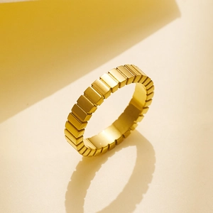 Macro detail of geometric ice cube design gold stainless steel ring with mirror finish