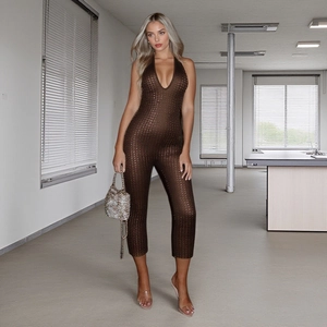 Detail shot of brown halter neck jumpsuit featuring shimmering fabric and deep V-neckline
