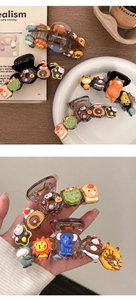 Close-up of large acrylic hair claw clip with 3D resin cartoon animals and donuts