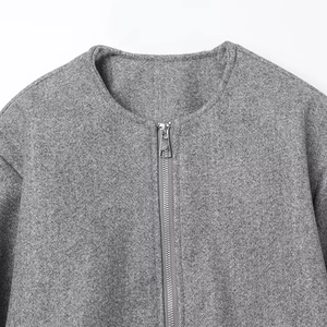 Detail view of round neckline and metal zipper on gray wool felt bomber jacket
