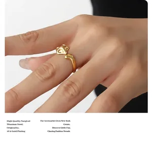 Detailed close-up of 18K gold plated fox open ring on model hand with dark background
