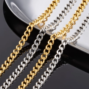 Golden and silver stainless steel Cuban link chains arranged on a reflective surface