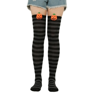 Detail of Halloween over-the-knee socks with black grey stripes and 3D pumpkin decor