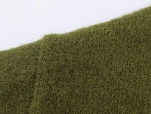 Detailed macro shot of olive green mohair knit fabric showing soft plush fiber texture