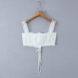 Detailed view of white lace trim camisole with ruched fabric and front drawstring tie