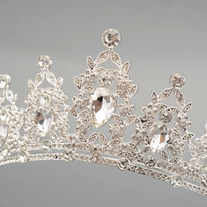 Close-up of luxury silver crown with water drop gemstone and floral rhinestone details