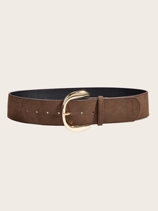 Detail of a brown suede wide belt for women featuring a large polished gold metal buckle